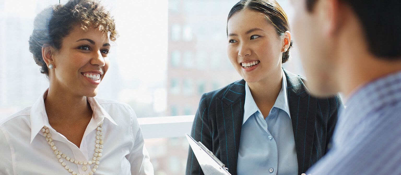 Diverse group of business people smiling and talking